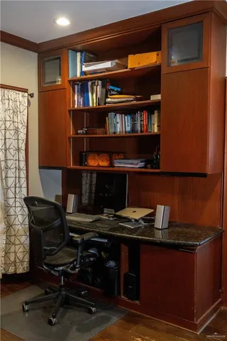 a workspace with furniture and a book shelf