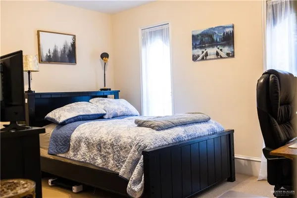 a bedroom with bed and tv