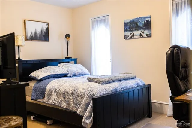 a bedroom with bed and tv