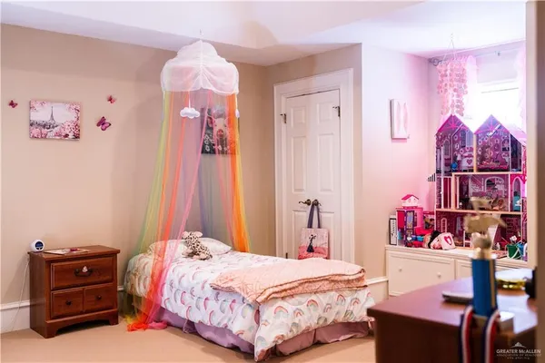 a bedroom with a bed and a dresser in it