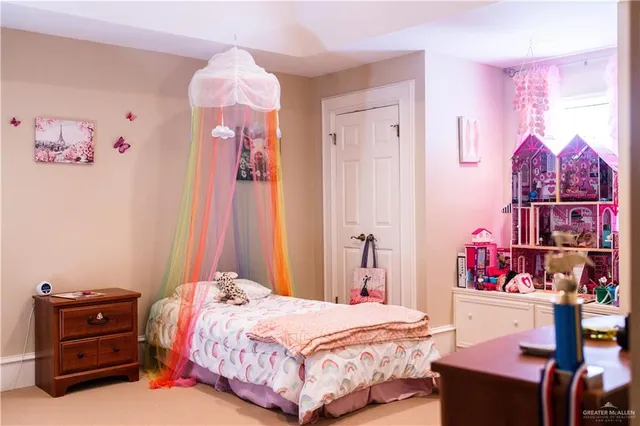 a bedroom with a bed and a dresser in it