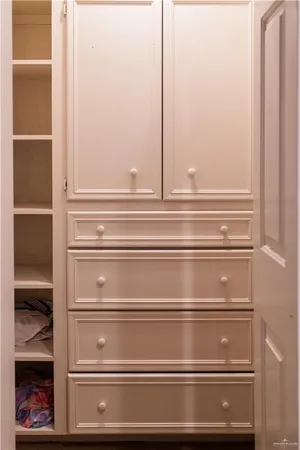 a room with lots of books and furniture