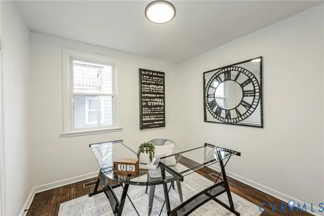a view of a workspace with furniture and a window