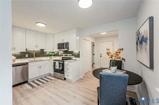 a view of a dining room with furniture window and wooden floor