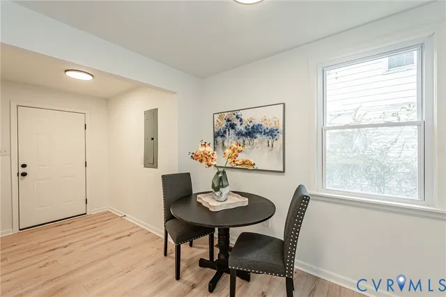 a view of a dining room with furniture window and wooden floor