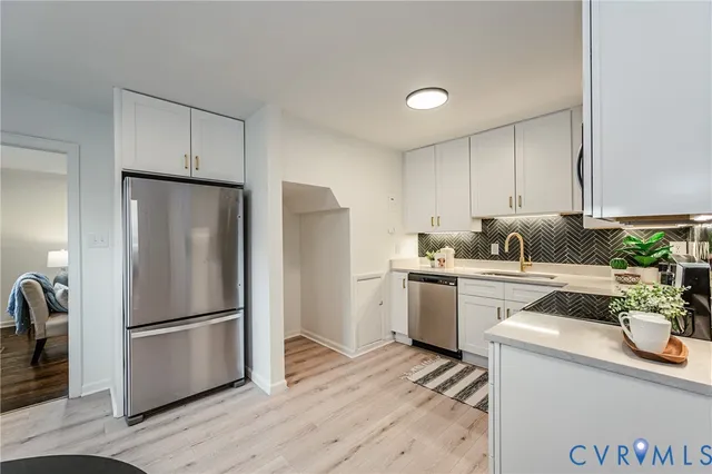 a kitchen with a sink stove and cabinets