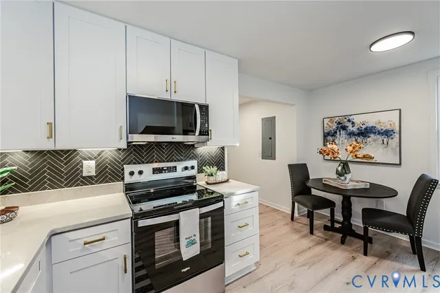 a view of a dining room with furniture and a window