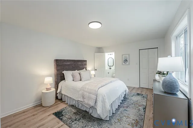 a bedroom with a bed and a lamp