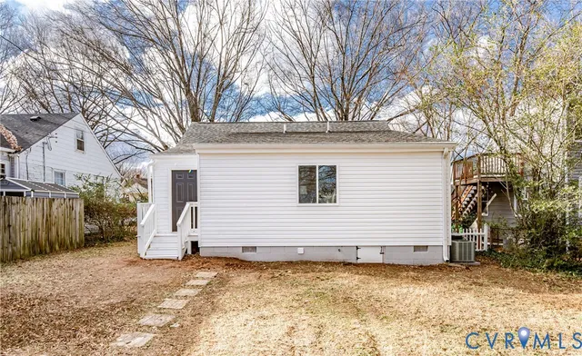 a view of a white house with many windows and trees
