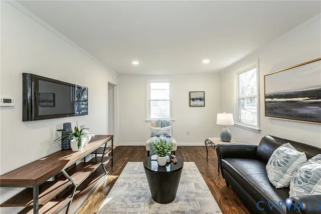 a living room with furniture a window and a flat screen tv