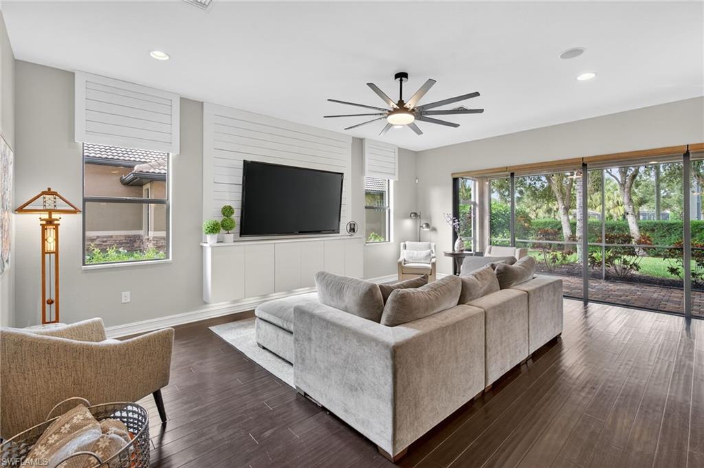 7235 Acorn Way Naples, FL 34119 - Photo 13 of 40 a living room with furniture and a flat screen tv
