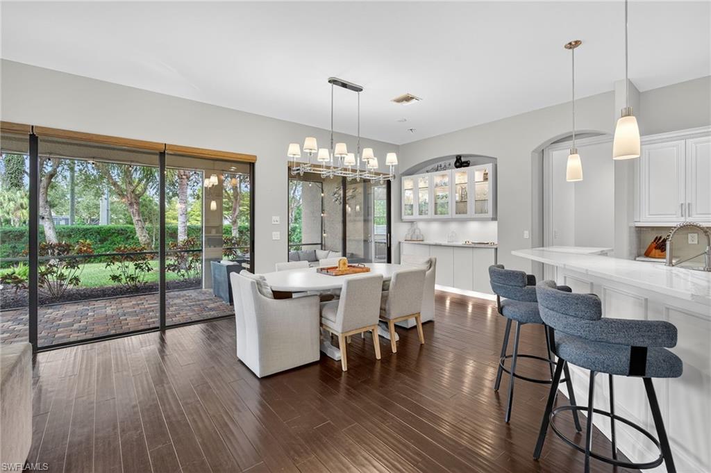 7235 Acorn Way Naples, FL 34119 - Photo 17 of 40 a view of a dining room with furniture window and wooden floor