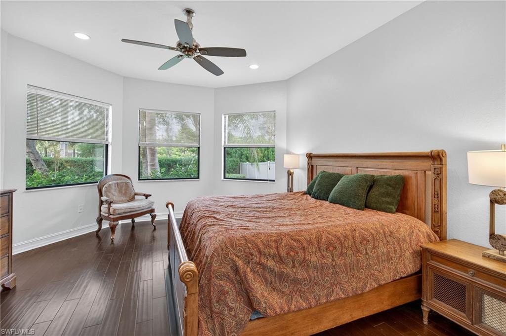 7235 Acorn Way Naples, FL 34119 - Photo 21 of 40 a bedroom with a bed and a large window