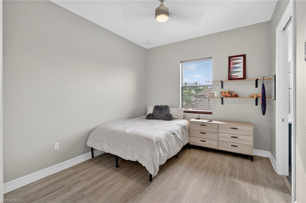 7235 Acorn Way Naples, FL 34119 - Photo 26 of 40 a bedroom with a bed and a window
