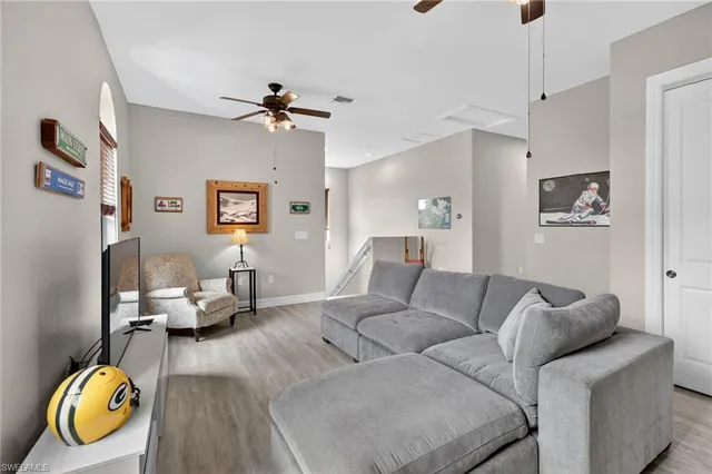 a living room with furniture chess board and a window