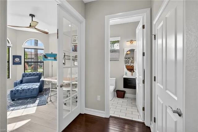 a view of a hallway with wooden floor and windows