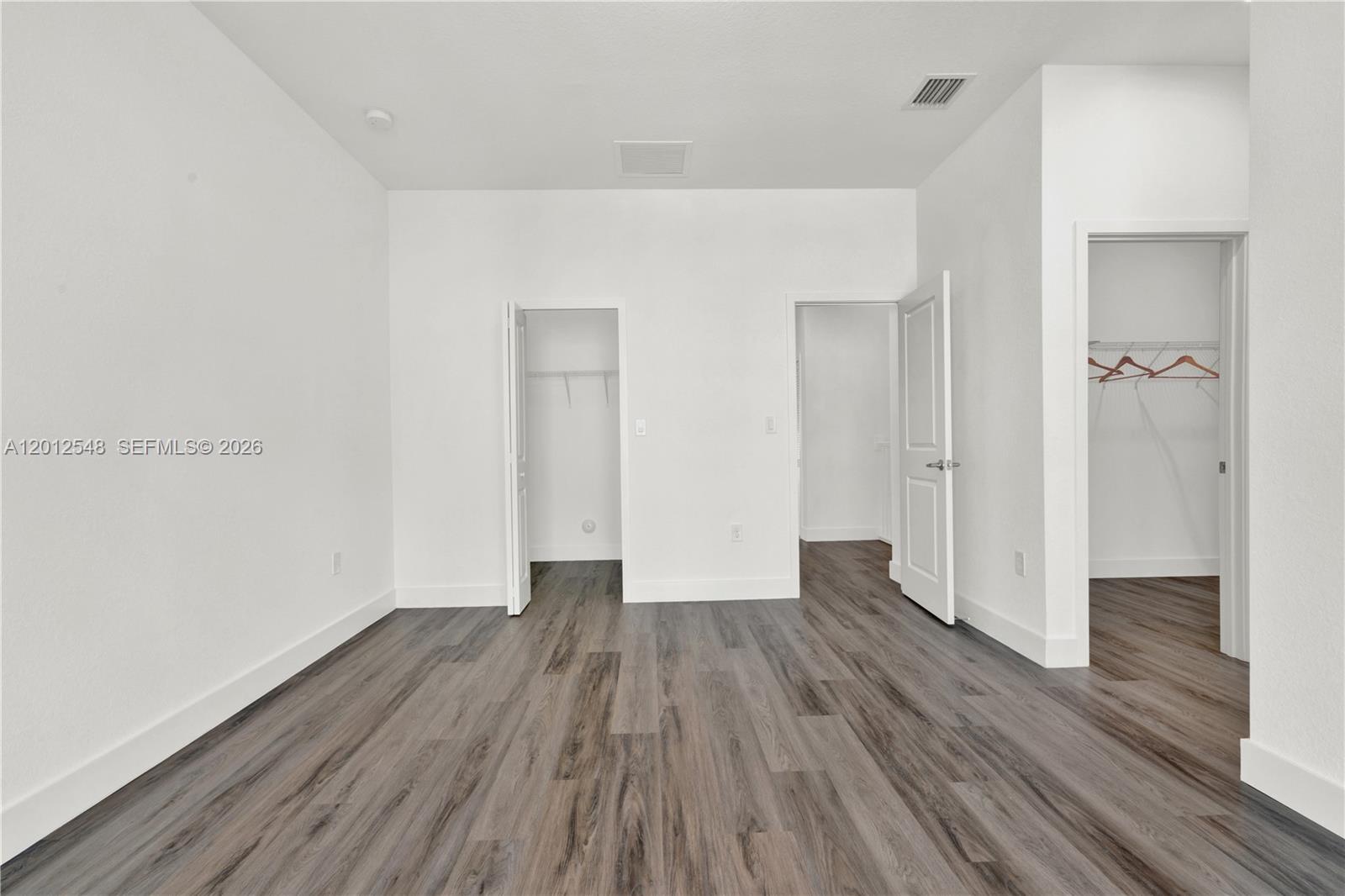 13642 Southwest 157th Place, Unit 13642 Miami, FL 33196 - Photo 21 of 41 a view of an empty room with wooden floor