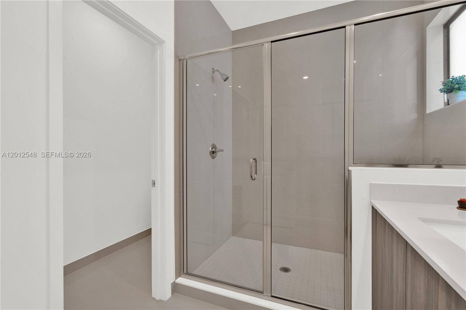 13642 Southwest 157th Place, Unit 13642 Miami, FL 33196 - Photo 26 of 41 a bathroom with a shower and a sink