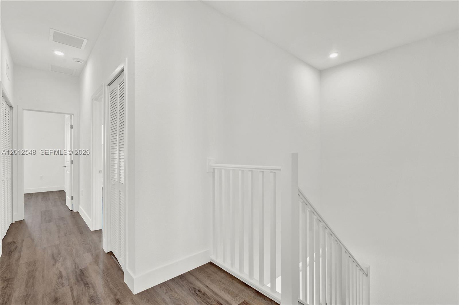 13642 Southwest 157th Place, Unit 13642 Miami, FL 33196 - Photo 27 of 41 a view of a hallway with wooden floor