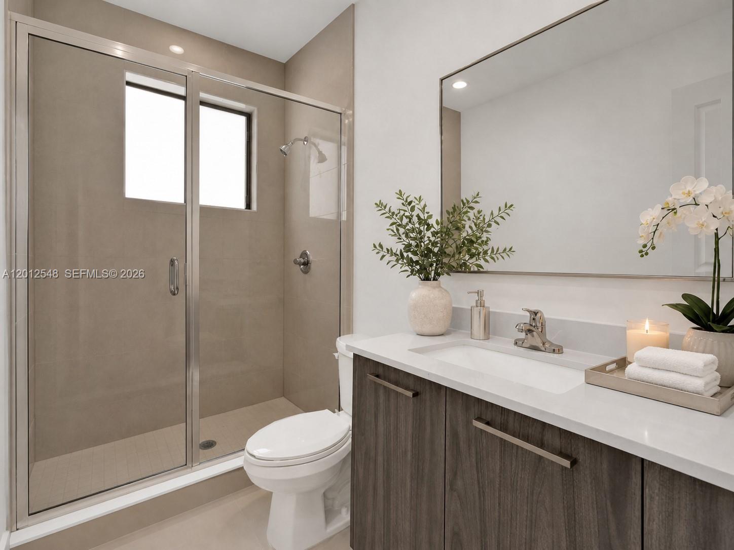13642 Southwest 157th Place, Unit 13642 Miami, FL 33196 - Photo 33 of 41 a bathroom with a granite countertop sink toilet and shower