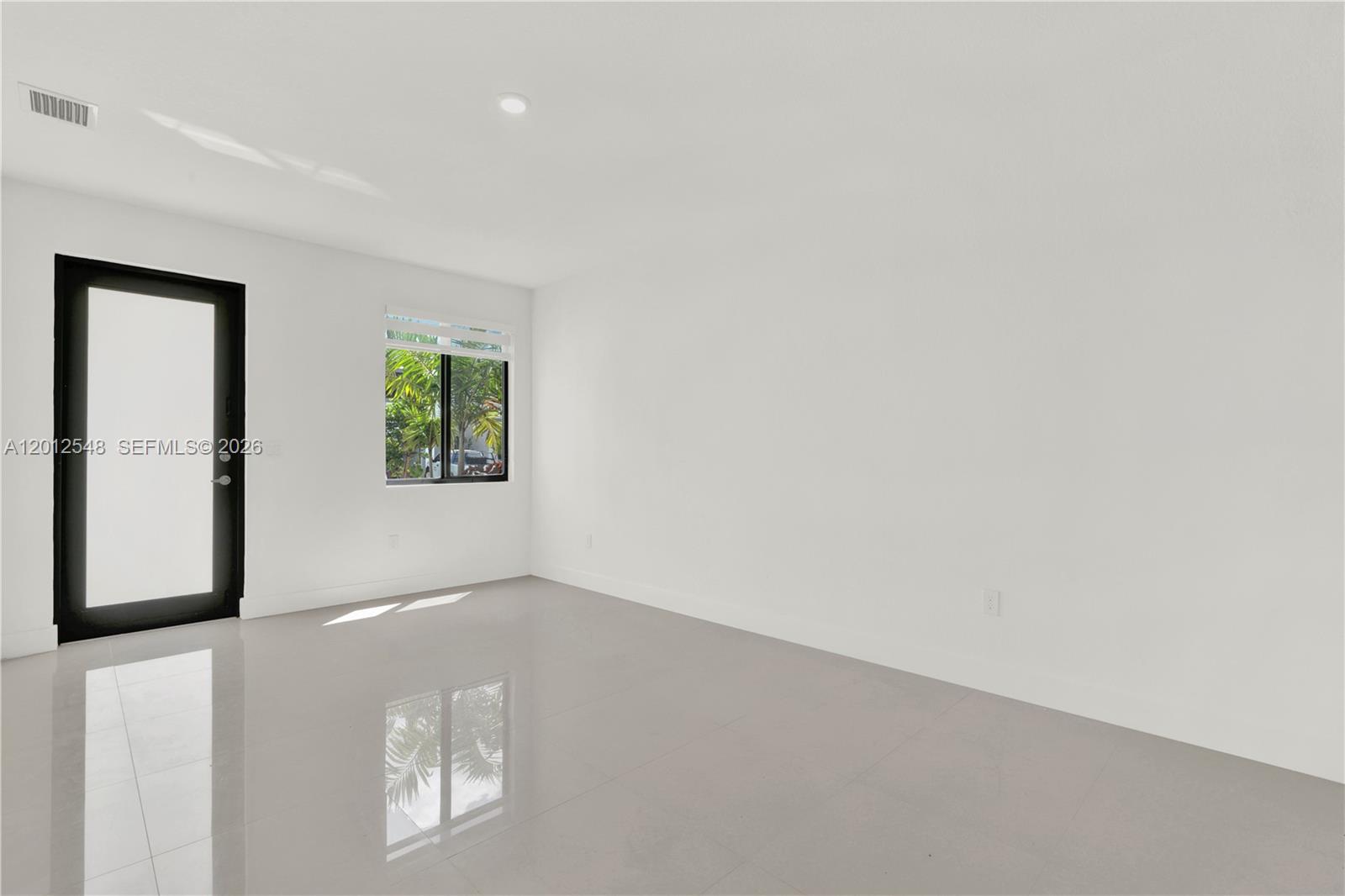 13642 Southwest 157th Place, Unit 13642 Miami, FL 33196 - Photo 6 of 41 an empty room with windows and closet