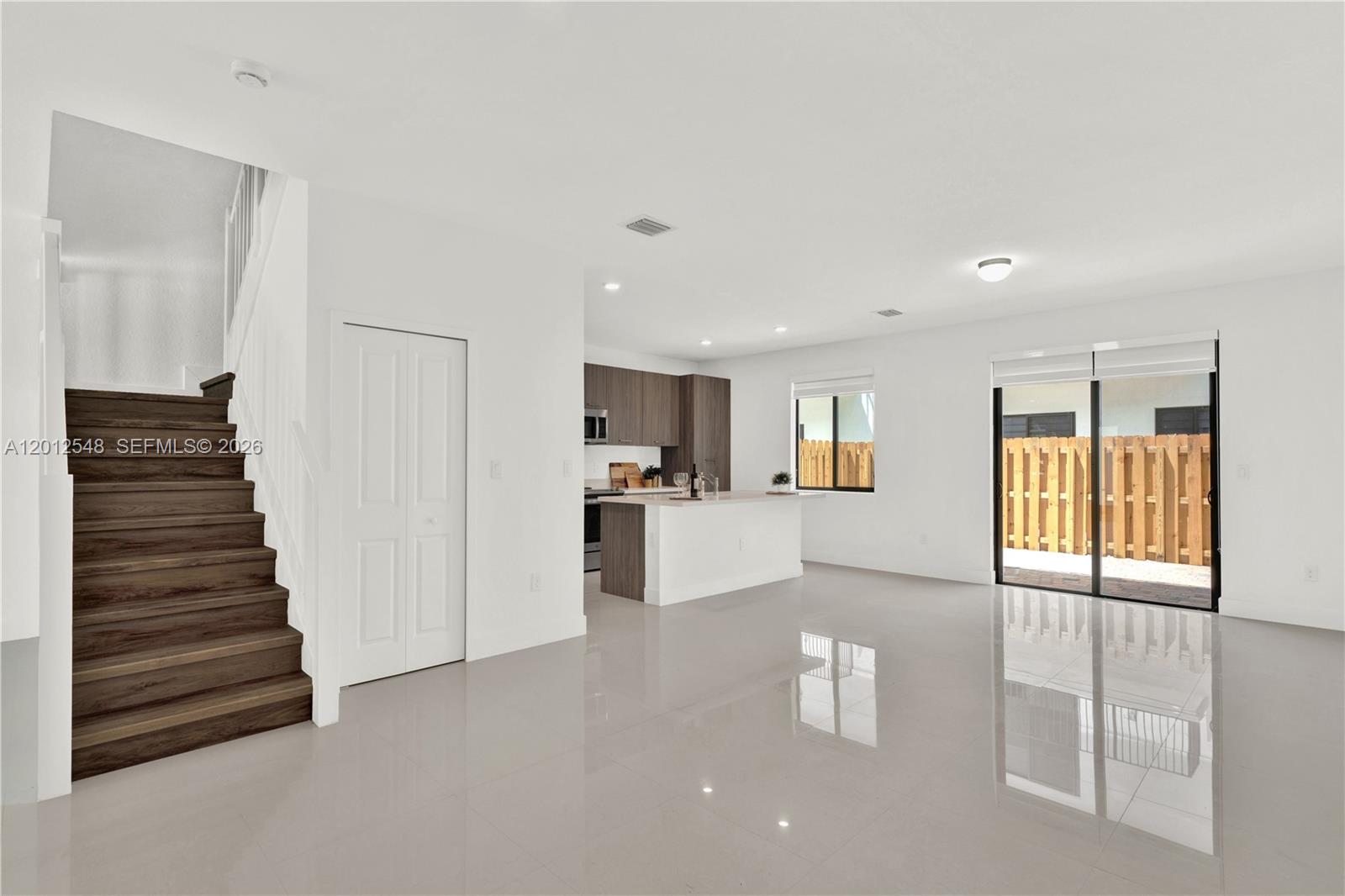 13642 Southwest 157th Place, Unit 13642 Miami, FL 33196 - Photo 10 of 41 a view of kitchen and hall with wooden floor