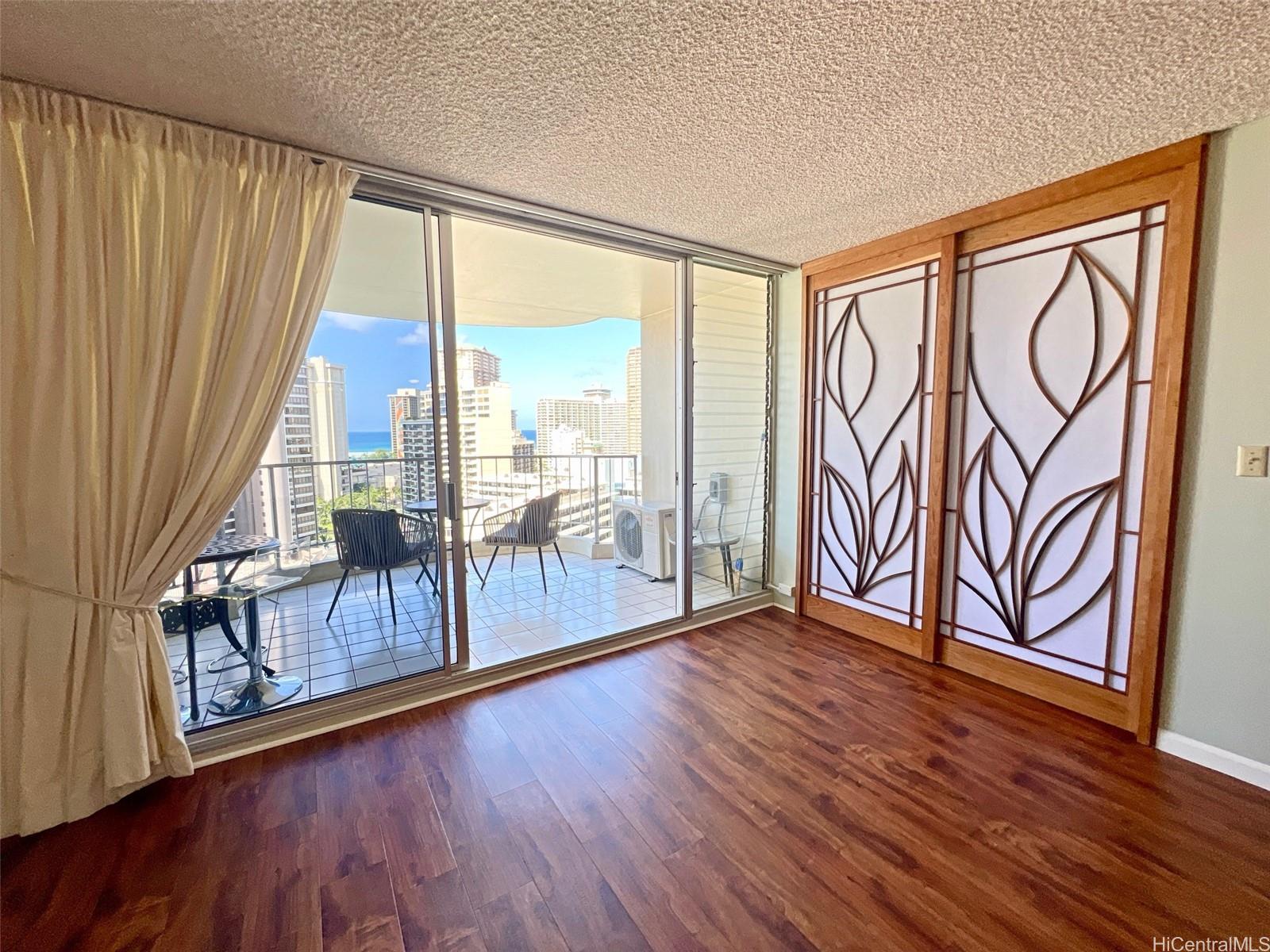 469 Ena Road, Unit 2010 Honolulu, HI 96815 - Photo 6 of 25 Living room looking toward lanai and primary bedroom door