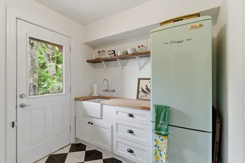 a kitchen with a refrigerator and a stove