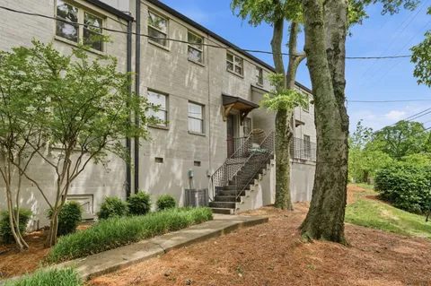 a brick building with a tree in front of it