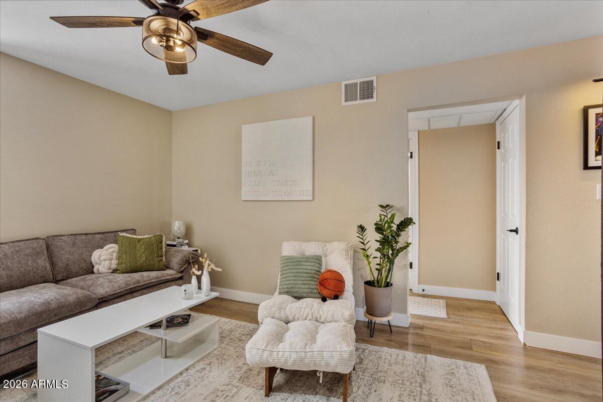 7510 East Thomas Road, Unit 216 Scottsdale, AZ 85251 - Photo 12 of 19 a living room with furniture and wooden floor