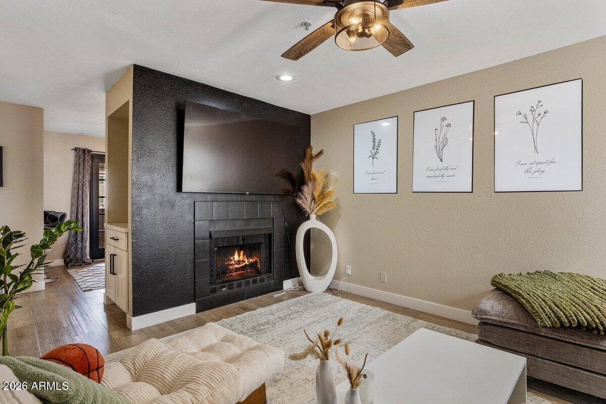 7510 East Thomas Road, Unit 216 Scottsdale, AZ 85251 - Photo 13 of 19 a living room with furniture and a fireplace