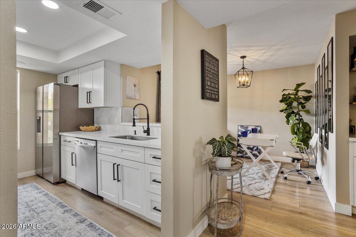 7510 East Thomas Road, Unit 216 Scottsdale, AZ 85251 - Photo 15 of 19 a kitchen with stainless steel appliances a sink and cabinets
