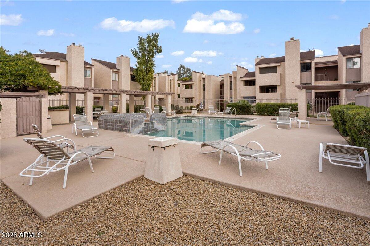 7510 East Thomas Road, Unit 216 Scottsdale, AZ 85251 - Photo 17 of 19 a view of a patio with a table and chairs and potted plants