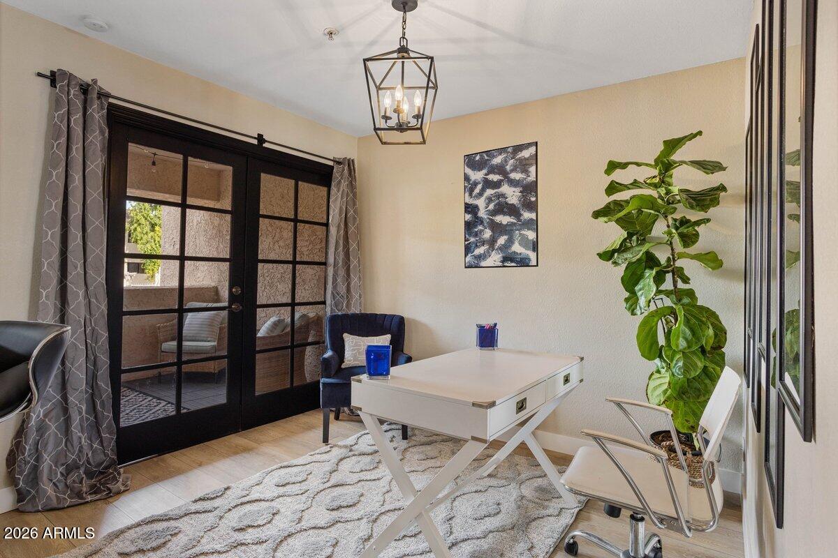 7510 East Thomas Road, Unit 216 Scottsdale, AZ 85251 - Photo 2 of 19 a workspace with furniture and a potted plant