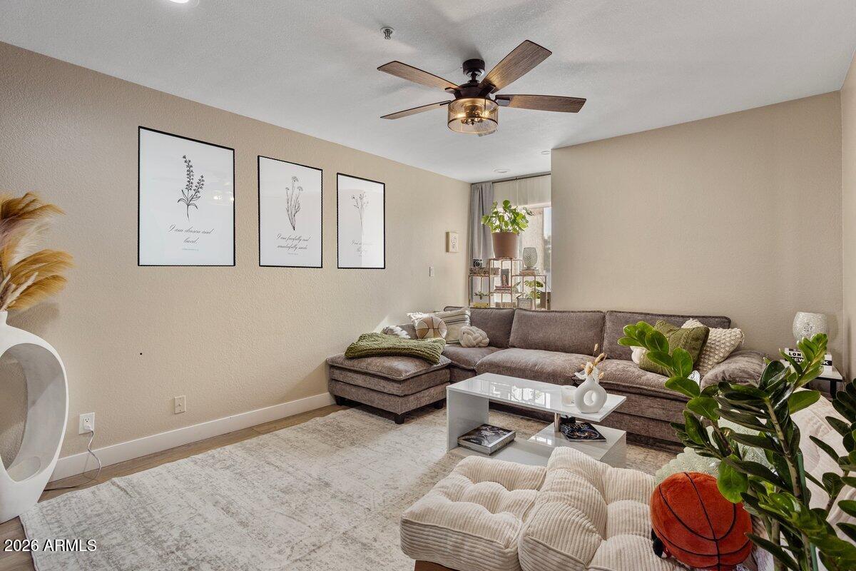 7510 East Thomas Road, Unit 216 Scottsdale, AZ 85251 - Photo 4 of 19 a living room with furniture and wooden floor