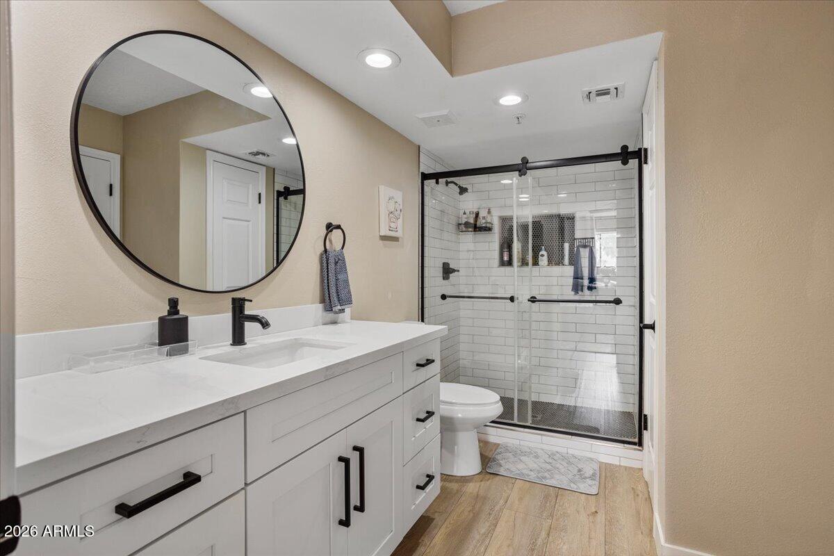 7510 East Thomas Road, Unit 216 Scottsdale, AZ 85251 - Photo 8 of 19 a spacious bathroom with a sink a toilet and a mirror