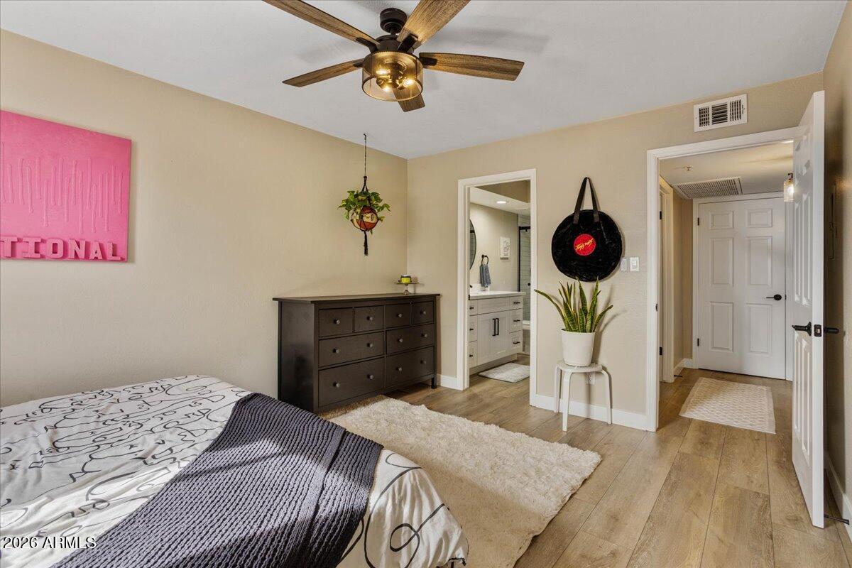7510 East Thomas Road, Unit 216 Scottsdale, AZ 85251 - Photo 9 of 19 a bedroom with a bed and a chandelier
