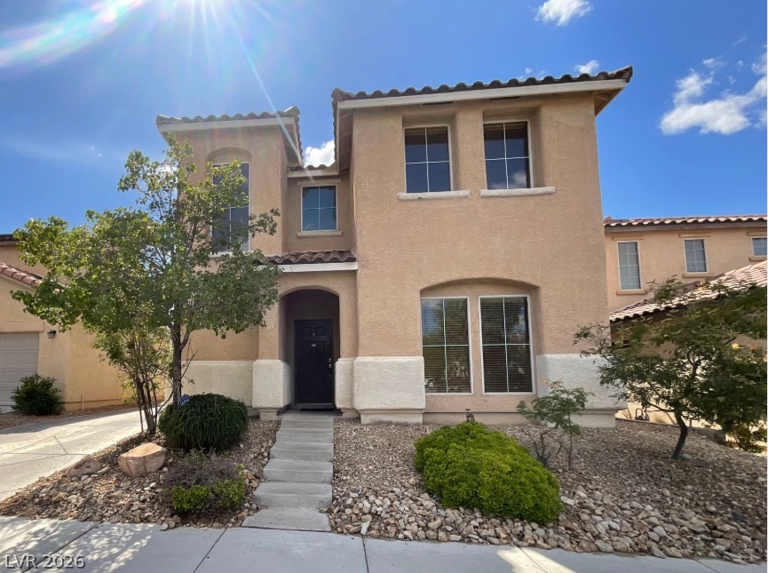 10841 Paradise Road Henderson, NV 89052 - Photo 1 of 35 A classic stucco facade with a tiled roof creates inviting curb appeal.
