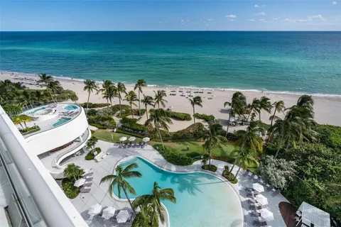 an aerial view of a houses with a yard