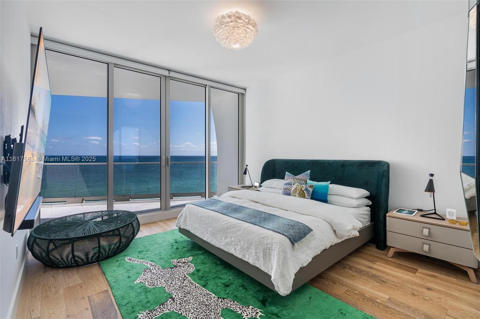 16901 Collins Avenue, Unit 902 Sunny Isles Beach, FL 33160 - Photo 14 of 52 a bedroom with a bed a table and chair