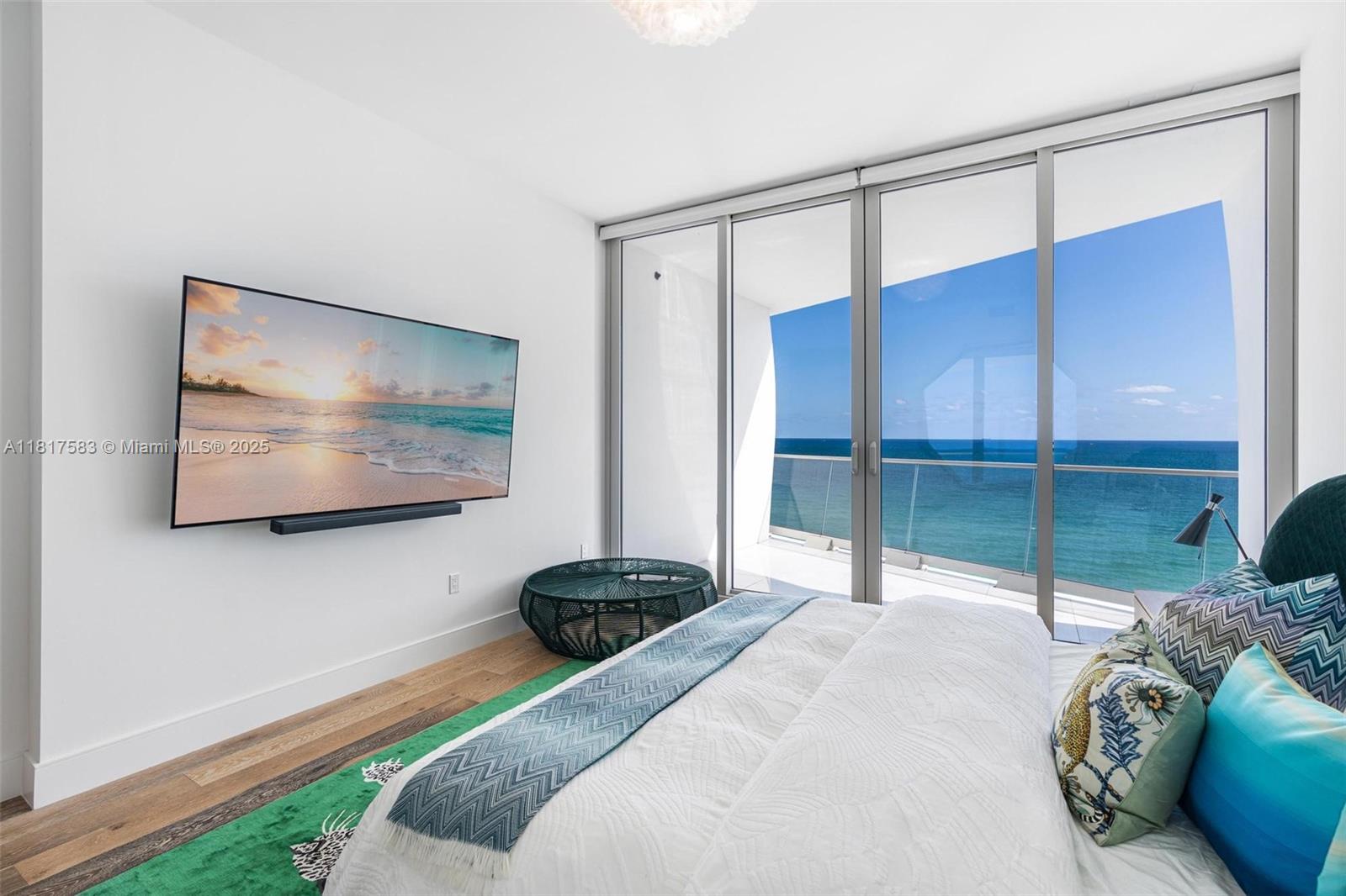 16901 Collins Avenue, Unit 902 Sunny Isles Beach, FL 33160 - Photo 15 of 52 a bedroom with a bed and a view of balcony