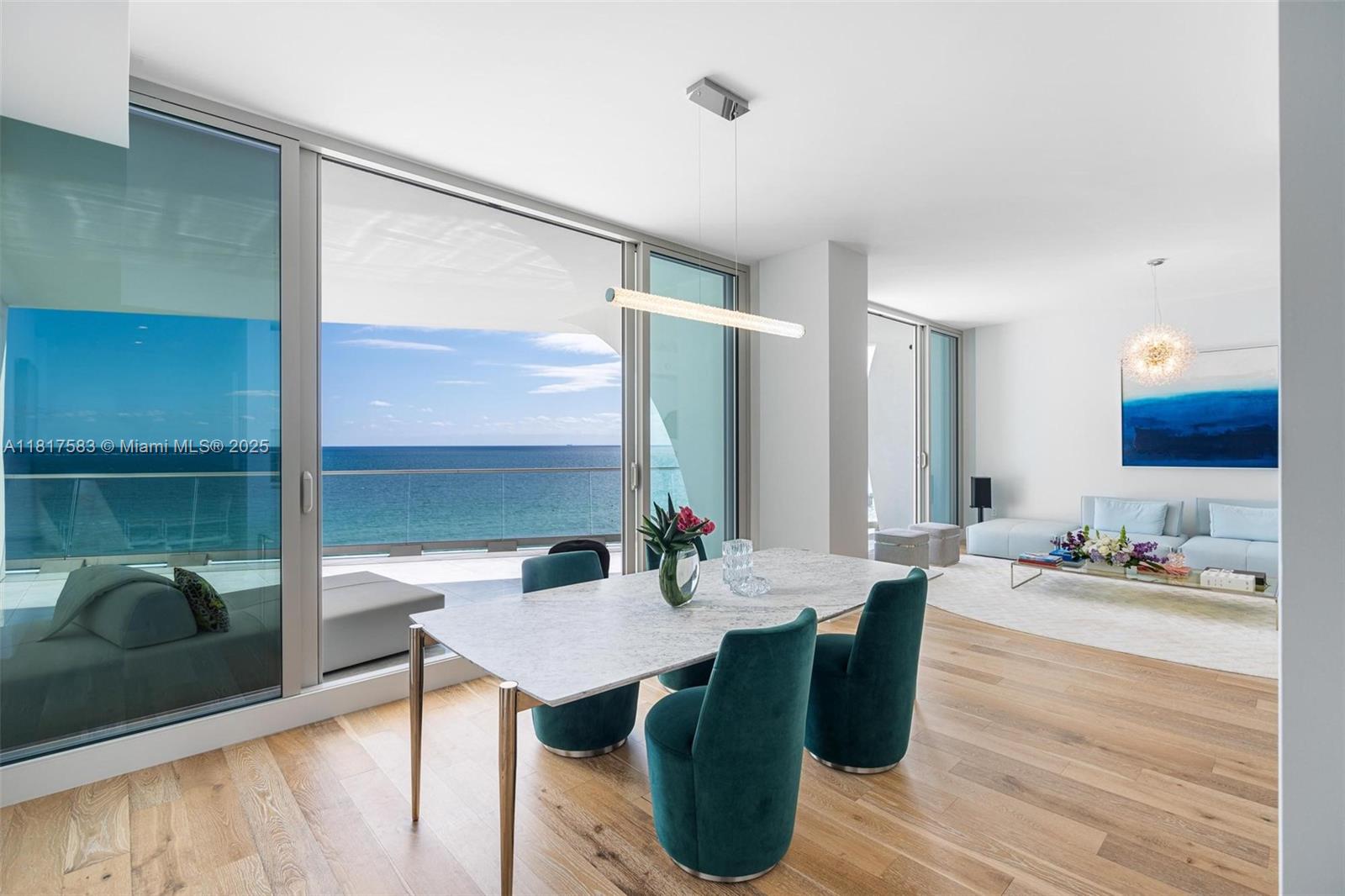 16901 Collins Avenue, Unit 902 Sunny Isles Beach, FL 33160 - Photo 2 of 52 a view of a dining room with furniture and wooden floor