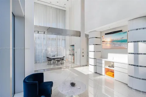 a view of a room with furniture and floor to ceiling window