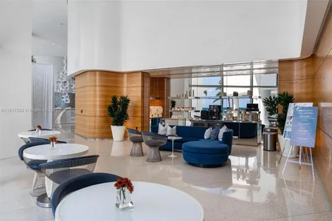 a kitchen with kitchen island granite countertop a sink a stove and a refrigerator