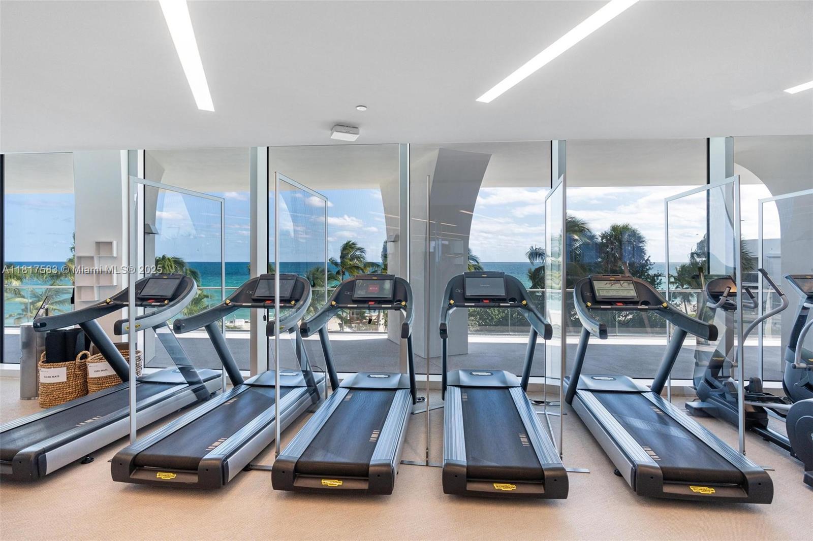 16901 Collins Avenue, Unit 902 Sunny Isles Beach, FL 33160 - Photo 47 of 52 a room with gym equipment and large windows