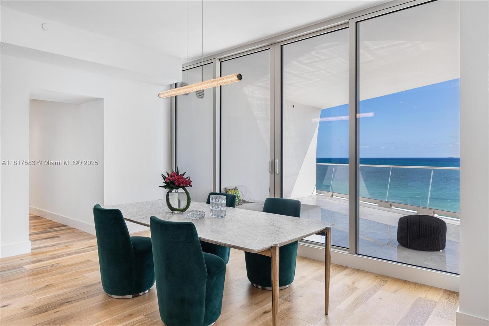 16901 Collins Avenue, Unit 902 Sunny Isles Beach, FL 33160 - Photo 5 of 52 a view of a dining room with furniture and wooden floor