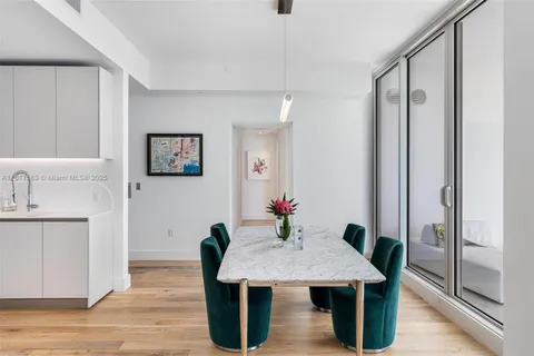 a view of a kitchen area with furniture and wooden floor