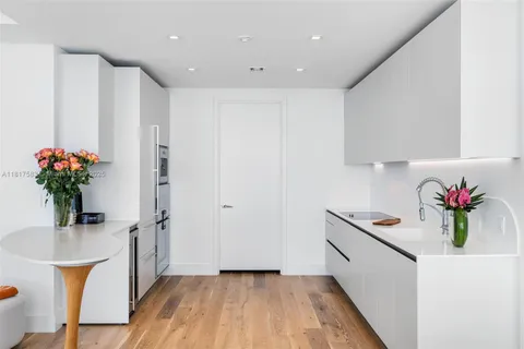 a hallway with a potted plant on a counter