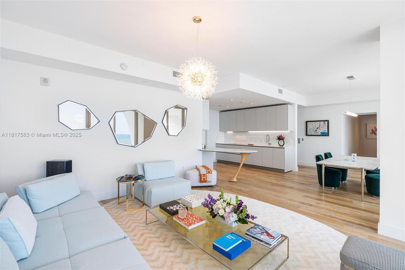 16901 Collins Avenue, Unit 902 Sunny Isles Beach, FL 33160 - Photo 10 of 52 a living room with furniture kitchen view and a chandelier