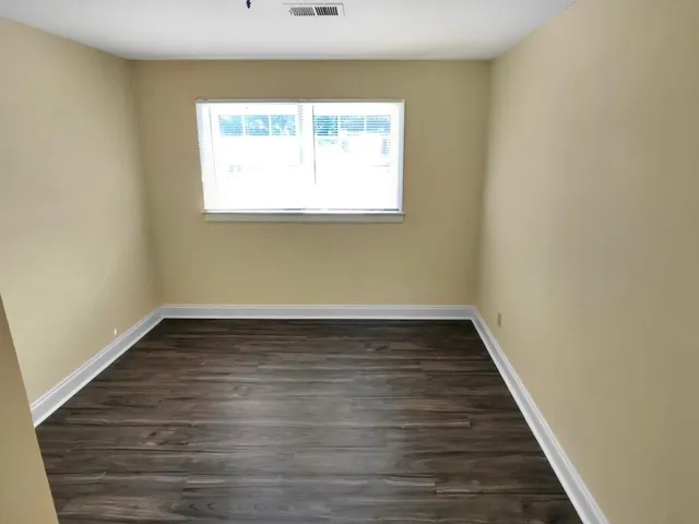 an empty room with wooden floor